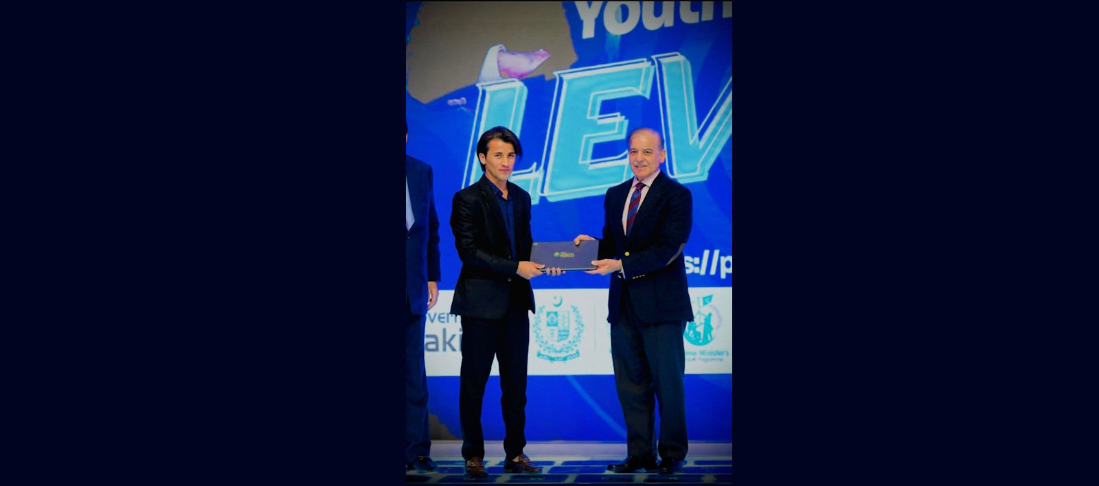 A proud moment as our BSIR student, Saqib Ul Islam  receives a laptop from the Prime Minister of Pakistan under PMYLS